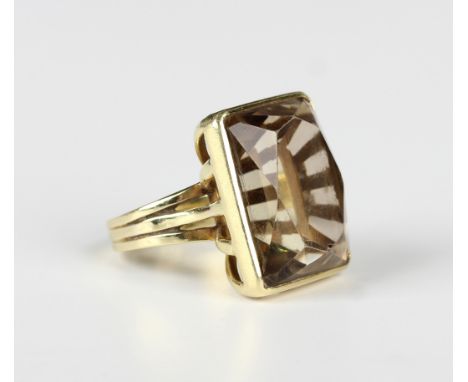 A gold ring, claw set with a large rectangular cut smoky quartz, detailed '750', weight 14.7g, ring size approx M.Buyer’s Pre