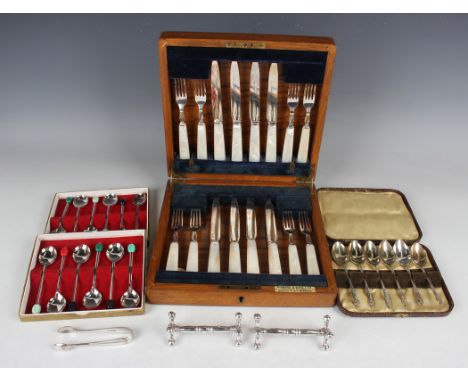 A group of plated items, including a set of eight dessert knives and forks with mother-of-pearl handles, cased, a stag antler