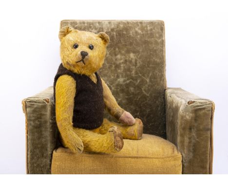 A 1920s Schuco yes/no teddy bear,  with golden mohair, black boot button eyes, pronounced muzzle, black stitched nose, mouth 