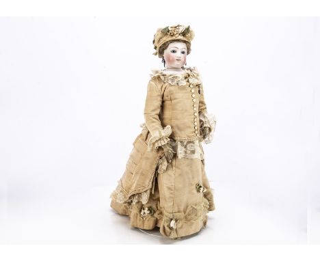 A large early unmarked Jumeau pressed bisque fashionable doll,  with deep blue striated glass eyes, closed mouth slightly smi