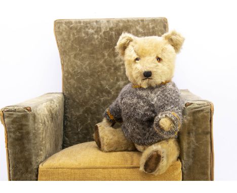 A post-war Chiltern Hugmee teddy bear,  with blonde mohair, orange and black glass eyes, black stitched nose, mouth and claws