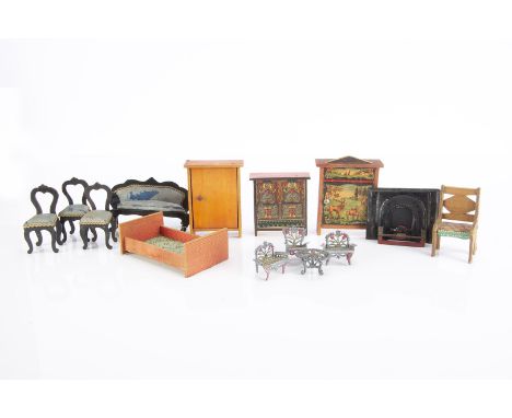 Smaller scale dolls’ house furnitures,  black painted sofa and three balloon backed chairs with blue upholstery —2¾in. (7cm.)