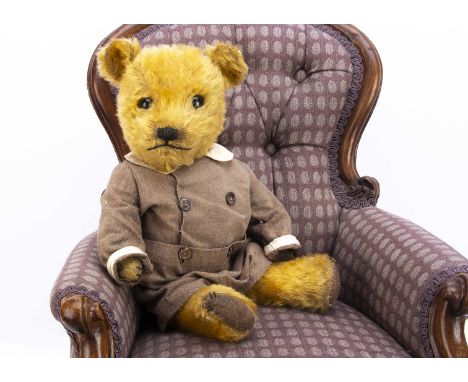 A 1940s Chiltern Hugmee  teddy bear,  with golden mohair, clear and black glass eyes with brown painted backs, pronounced squ