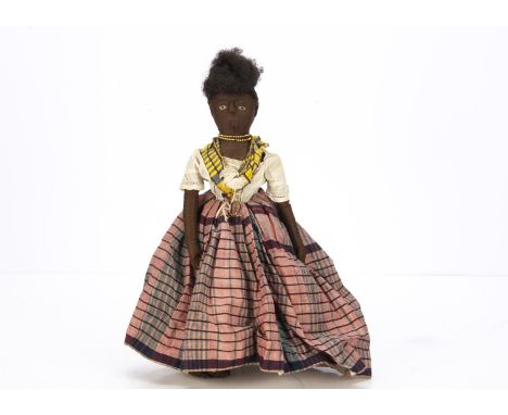 A late 19th century hand-stitched black cloth doll,  probably West Indies with black bead and white stitched eyes, raised nos