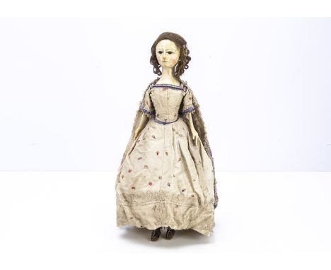 A fine and unusual late 18th century English carved and painted wooden doll, with inset dark enamel eyes, short dashed eye la