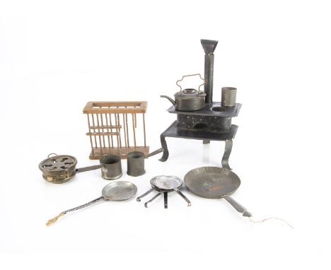 An early tinplate dolls’ house stove, black painted with two rings, oven and chimney —6in. (15cm.) high; a tinplate frying pa