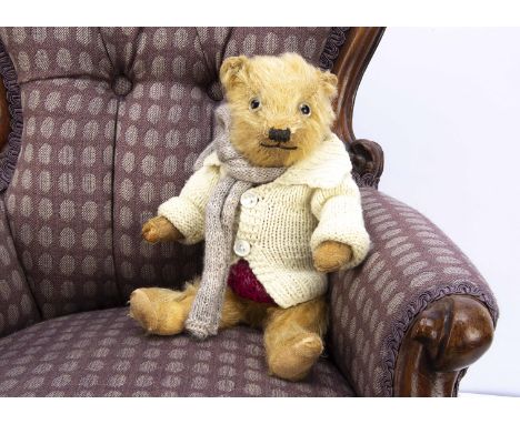 A 1930s small Chiltern-type teddy bear,  with golden mohair, clear and black glass eyes, pronounced muzzle with black stitche