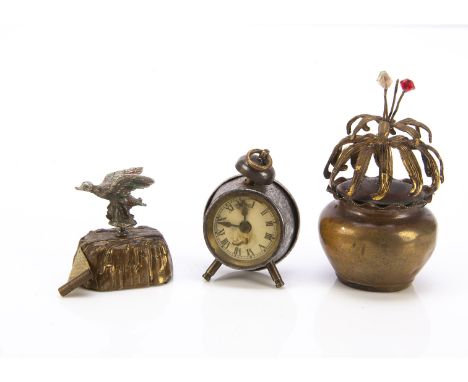 Three novelty tape measures,  a brass flower pot with spinning flowers —3in. (7.5cm.) high; a duck flying over a stump and an