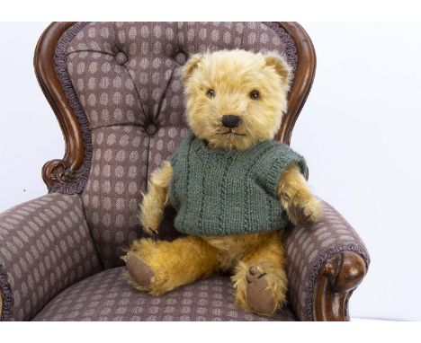 A 1940s Chiltern Hugmee  teddy bear,  with golden mohair, orange and black glass eyes, muzzle with black stitched nose, mouth