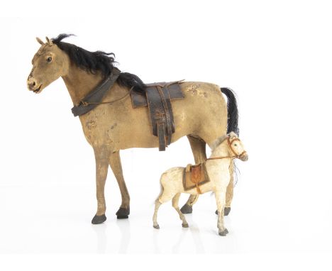 A good quality skin-covered toy horse,  light brown fur, inset glass eyes, wool plush mane, horse hair tail, leather saddle a