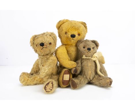 Three post-war Chad Valley teddy bears,  the smaller with blonde mohair mix plush, orange and black glass eyes, black stitche