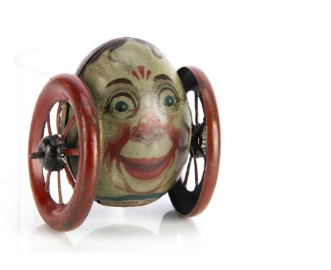 A rare Burnett Ltd tinplate Humpty Dumpty money bank on wheels, lithographed egg with face, the back with coin slot on back o