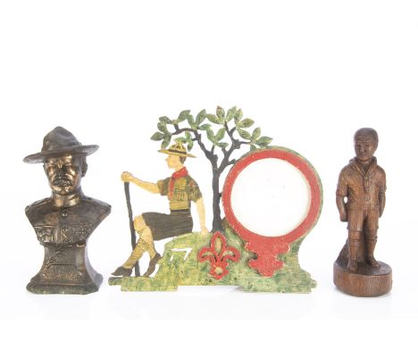 A spelter bust of Major General Baden-Powell, a fret-work and painted wood photograph frame with Boy Scout seated beside a tr