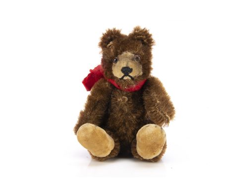 A 1930s miniature Steiff Teddy Baby,  with brown mohair, clear and black glass eyes with brown backs, inset velvet muzzle and