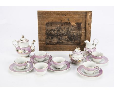 A mid 19th century porcelain doll's tea set in original box, six cups, five saucers, teapot, sugar basin and milk jug, painte