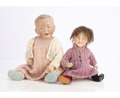 Two German bisque-headed character babies, a K * R 100 Kaiser baby with composition body and pink knitted dress —15in. (38cm.