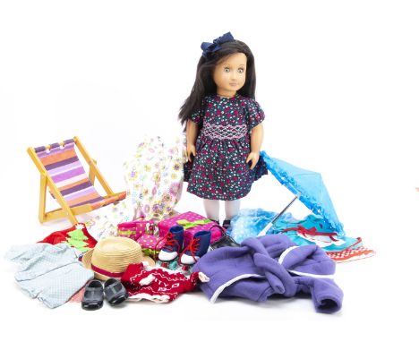 An Our Generation Elyse vinyl doll and accessories, including Our Generation travel set and beach accessories with deck chair