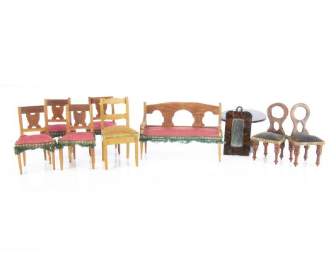 Dolls’ house furniture,  a sofa —4in. (10cm.) wide and four wooden chairs with pink upholstery and green fringing; a small pa