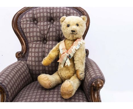 A German teddy bear 1910-1920s, with golden mohair, black boot button eyes, pronounced muzzle, black stitched nose, mouth and