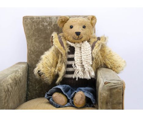 A German 1920s teddy bear,  with golden mohair, black boot button eyes, pronounce muzzle with black stitched nose and mouth, 