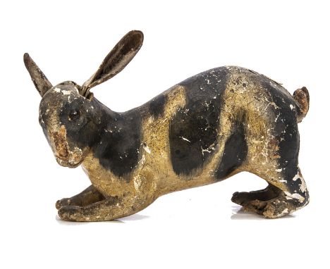 A rare 1820s painted carton primitive rabbit toy with provenance,  running or hopping with head turned to the right, painted 