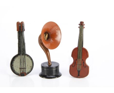 Three German Penny Toy sweet containers,  a horn speaker with candy container in base with original sweets —4¼in. (11cm.) hig