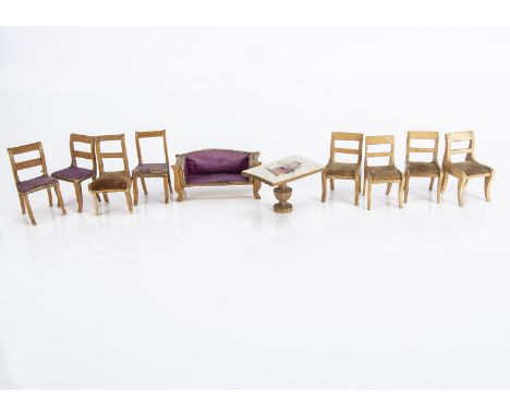 Small scale dolls’ house furniture,  a plain wood sofa —3in. (7.5cm.) wide and three chairs with purple upholstery and Dresde