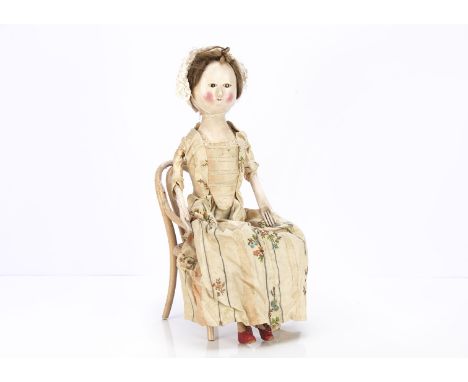 A restored George III English carved and painted wooden doll,  with inset dark enamel eyes, short dashed painted lases, curve