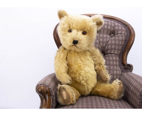 A post-war Chiltern Hugmee teddy bear,  with light golden mohair, black stitched nose, mouth and claws, swivel head, jointed 