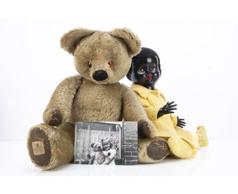 A post-war Chad Valley teddy bear,  with blonde mohair, orange and black plastic eyes, pronounced muzzle, black stitched bulb