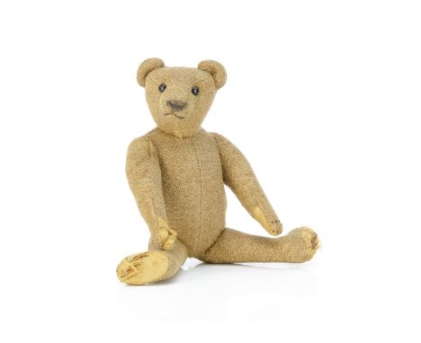 An early German burlap teddy bear circa 1910,  with brown burlap, black boot button eyes, pronounced muzzle, restitched nose 