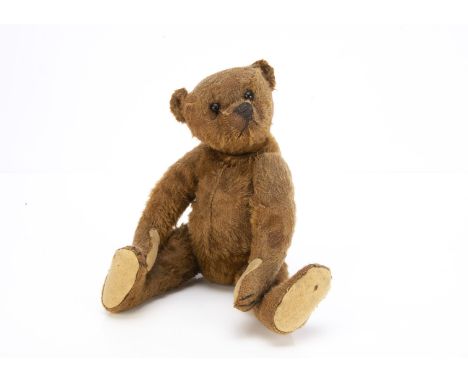 An early Steiff cinnamon mohair teddy bear circa 1909, with black boot button eyes, pronounced clipped muzzle, black stitched