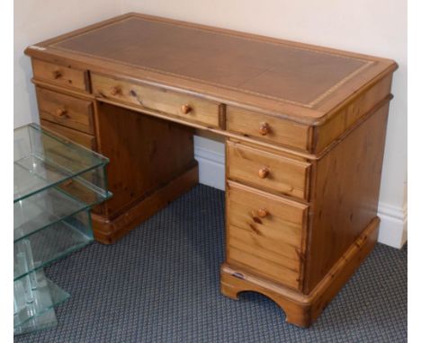 A pine kneehole desk, leather inset, 121cm by 61cm by 76cm