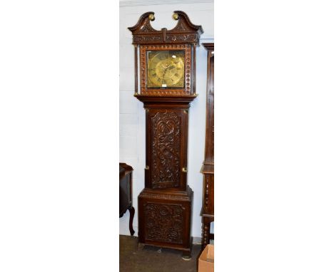 A carved oak thirty hour longcase clock, the square brass dial signed Ewbank, Elland 