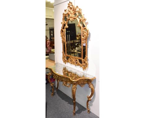 A modern mirrored gilt composition console table, 146cm by 48cm by 83cm in the rococo taste together with a similar gilt comp