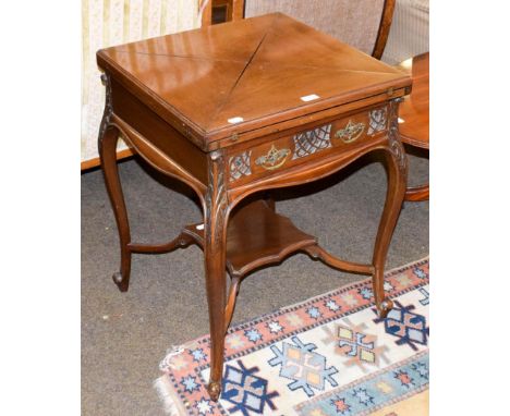 A 20th century mahogany envelope card table, raised upon carved scroll supports, 55cm square by 73cm high