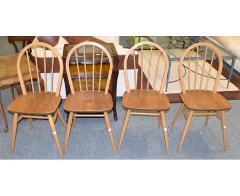 A set of four light elm hoop back dining chairs