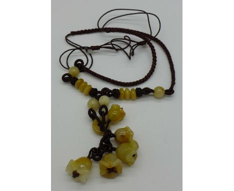 A yellow jade necklace, five flowers
