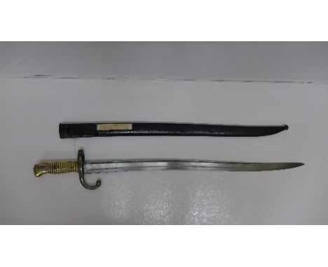 A French bayonet with scabbard, the top of the blade marked 1869