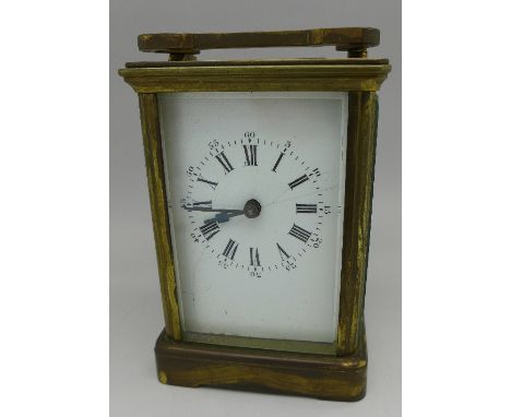 A brass carriage clock, the dial and one glass panel a/f, height of case 11cm