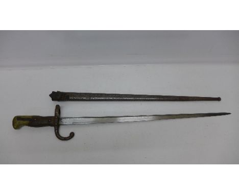 A French bayonet with scabbard, top of the blade marked 1879