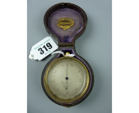 A gilt brass 19th Century pocket barometer with revolving bezel, the silvered dial marked 'Husbands, Optician, Bristol', in o