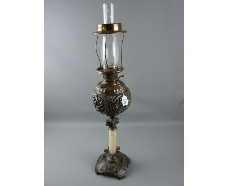 A Victorian cast metal oil lamp with onyx column, the base with winged cherub head decoration, Corinthian collar cap and pier