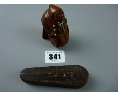 A finely carved early 19th Century coquilla nut snuff box in the form of a hunched portly gent in heavy overcoat and hat with