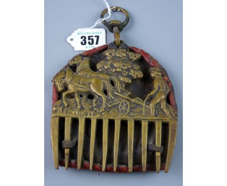 An antique brass horse mane comb decorated with a two team horse and plough and farmer before a tree, mounted on antique leat