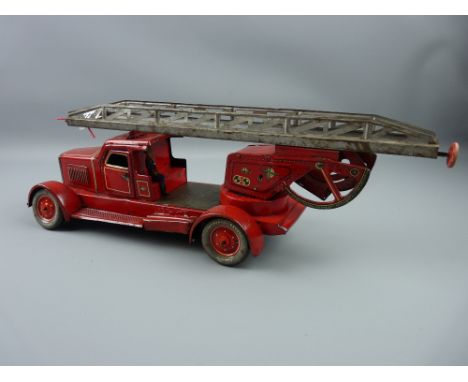 Toys - a Distler tinplate wind-up fire engine, one figure present, 45 cms long