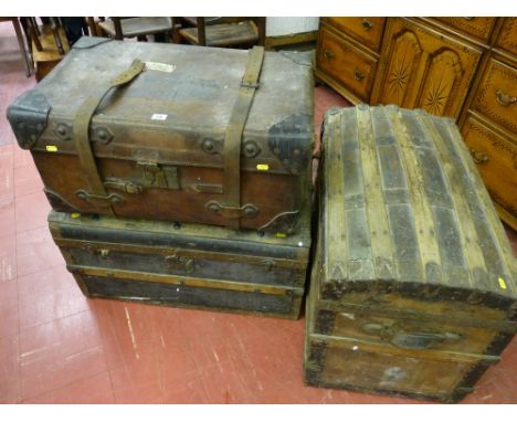 An antique leather steamer trunk marked 'W B M, Stoke-on-Trent' to the top and two further dome topped wooden steamer trunks 