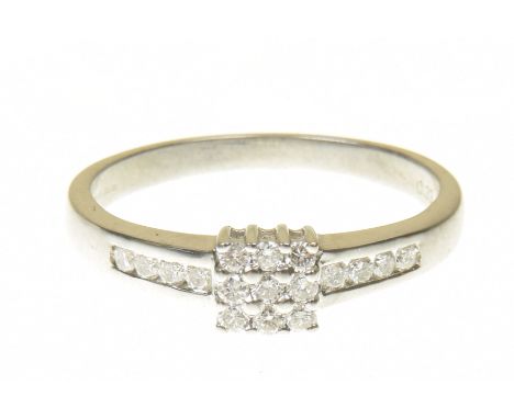 An 18ct gold diamond cluster ringThe brilliant cut diamond square shape grid with similarly cut diamond shoulders, total diam