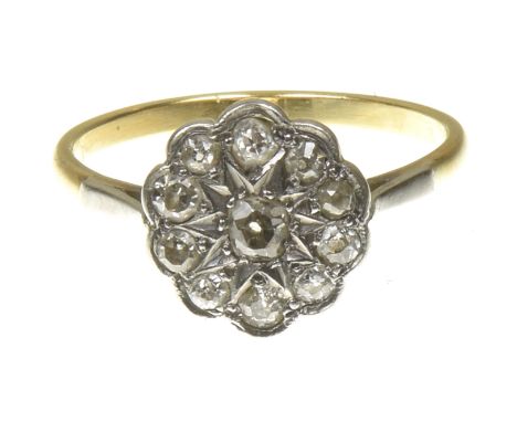 A diamond cluster ringThe old cut diamond, within a similarly cut diamond scalloped surround, estimated total diamond weight 