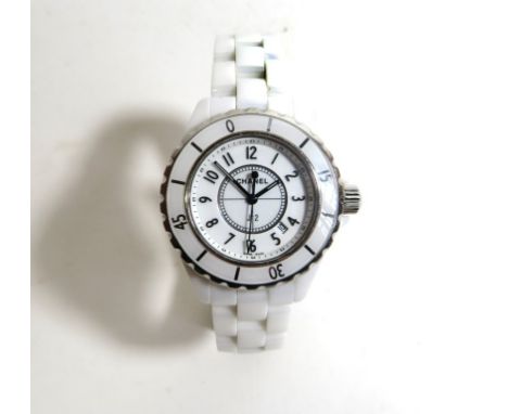 A ladies Chanel J12 wristwatchThe white circular dial with Arabic hour markers, date aperture to 4, and enamel calibrated bez